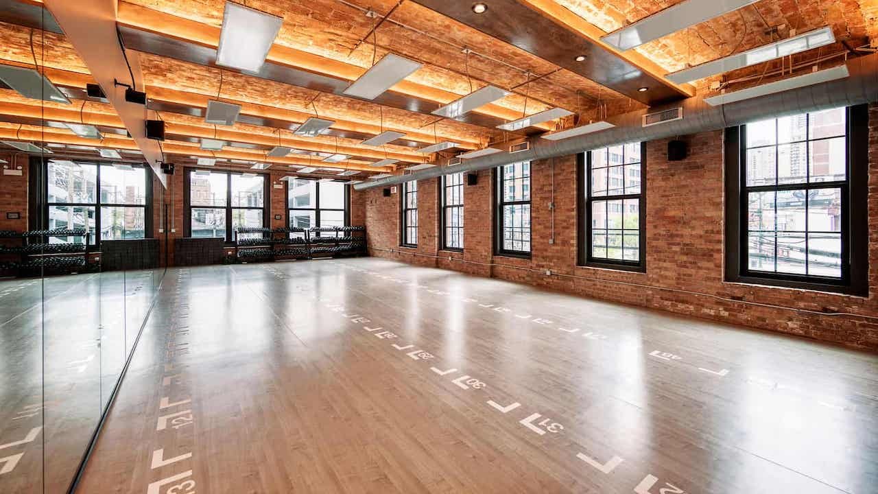 Inside the Yoga 2.0 studio — exposed brick, mirrors, and natural light